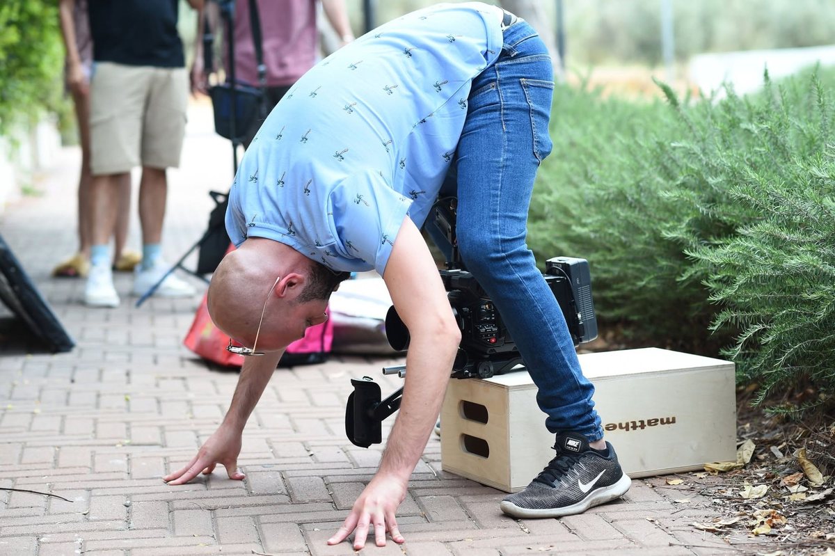 On set, leaning into the camera